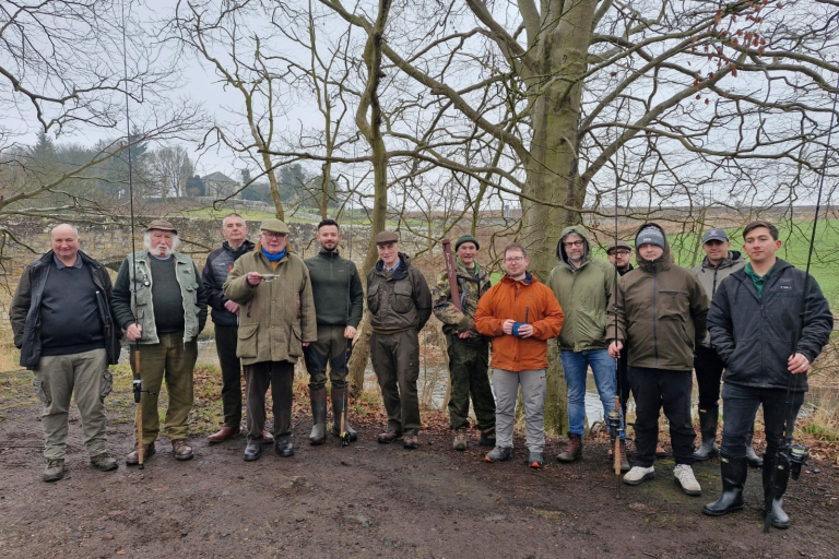 Eden Angling Association members pose beside the River Eden, Cupar